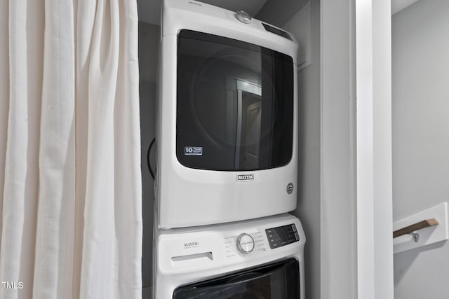 laundry area featuring laundry area and stacked washer and clothes dryer