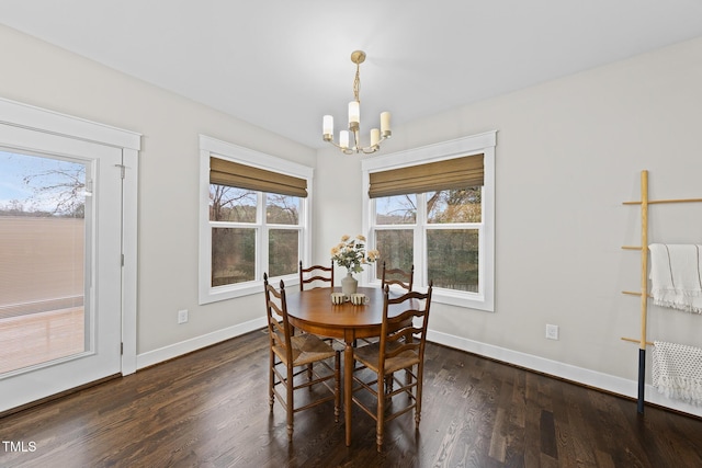 dining area with a notable chandelier, baseboards, and wood finished floors