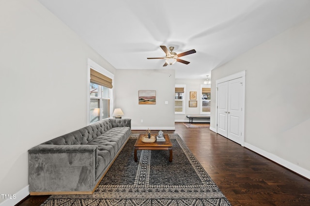 living room with a ceiling fan, dark wood-style flooring, and baseboards