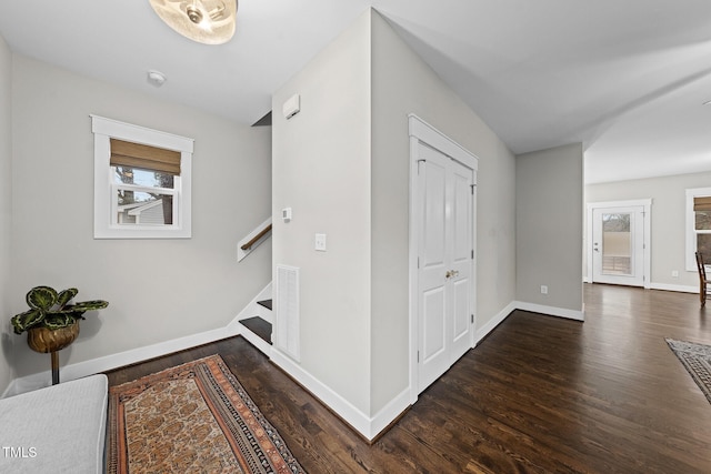 hallway with stairway, baseboards, and wood finished floors