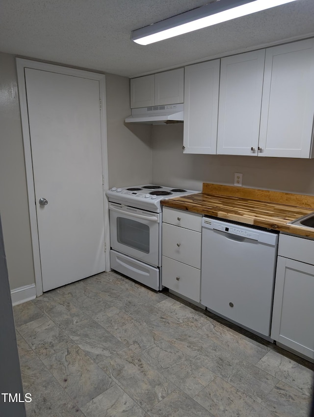 kitchen with white appliances, butcher block countertops, white cabinetry, and under cabinet range hood