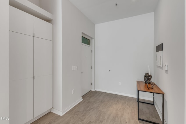 bedroom featuring light wood-type flooring and baseboards