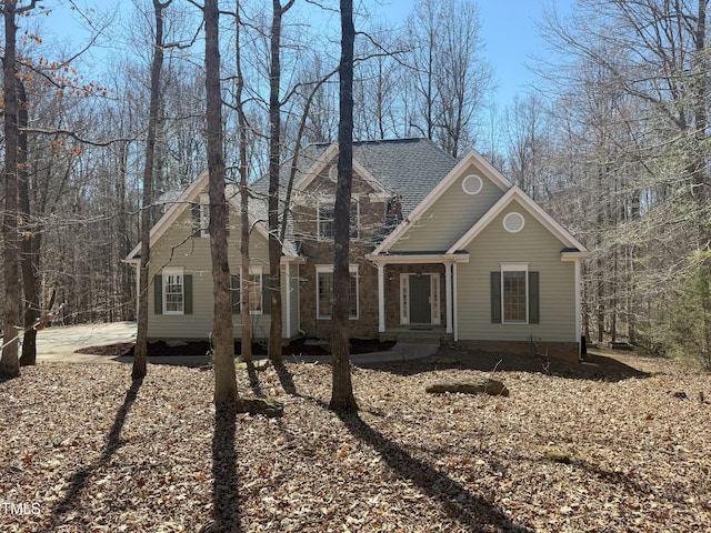 view of front facade featuring roof with shingles