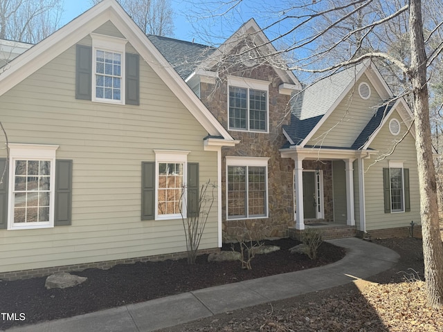 view of front of home with a shingled roof