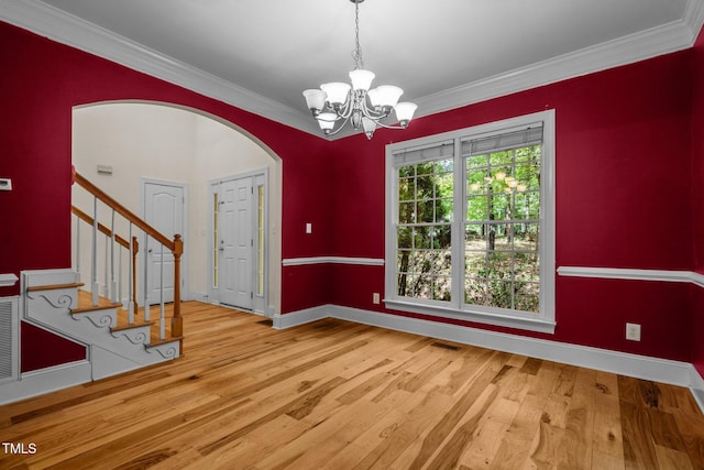 interior space with stairway, ornamental molding, and wood finished floors