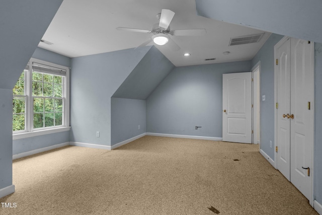 bonus room with baseboards, visible vents, vaulted ceiling, and carpet flooring