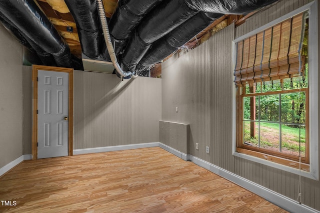 below grade area featuring baseboards and wood finished floors