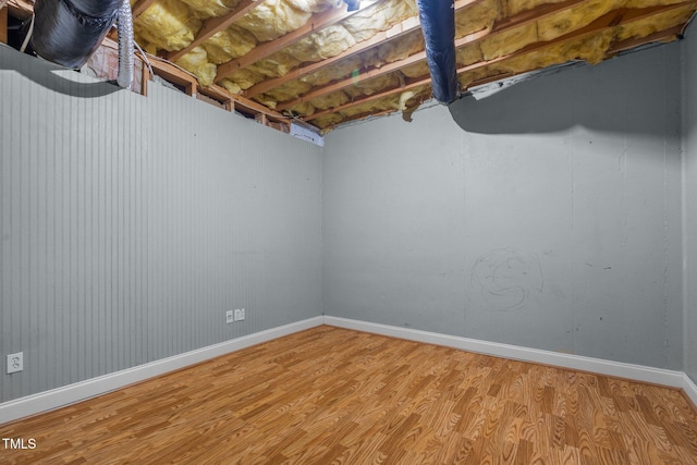 unfinished below grade area featuring baseboards and light wood-style floors