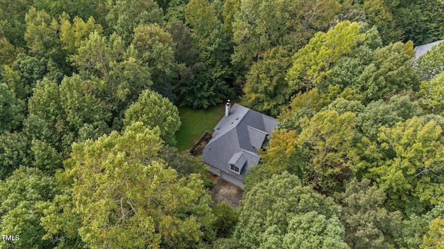 birds eye view of property with a view of trees