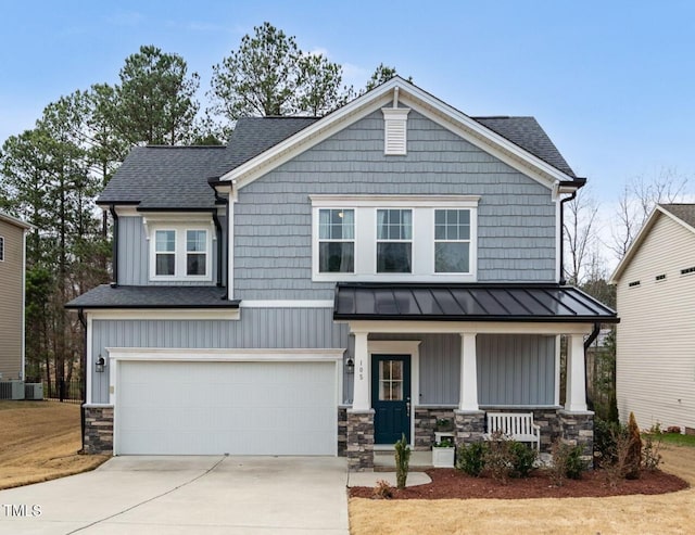 craftsman inspired home with a porch, an attached garage, a standing seam roof, stone siding, and driveway