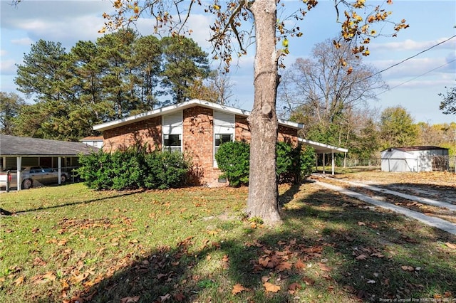 view of home's exterior featuring a yard, a carport, and brick siding