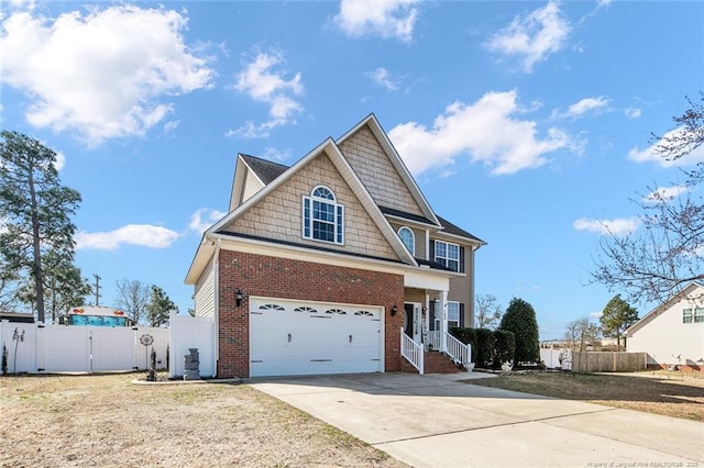 view of front of home featuring concrete driveway, brick siding, and fence