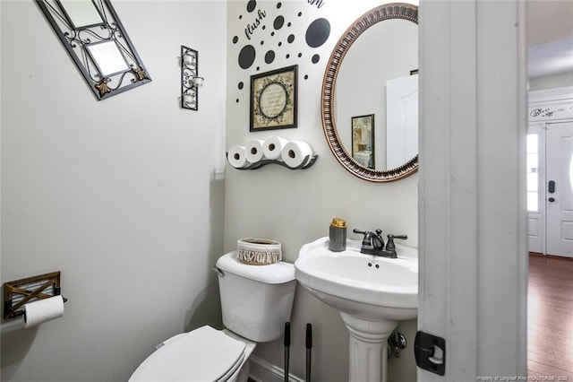 bathroom featuring toilet and wood finished floors