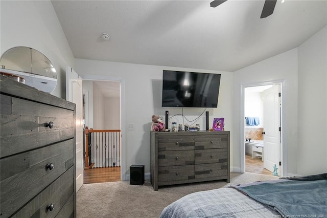 carpeted bedroom with lofted ceiling, ceiling fan, baseboards, and connected bathroom