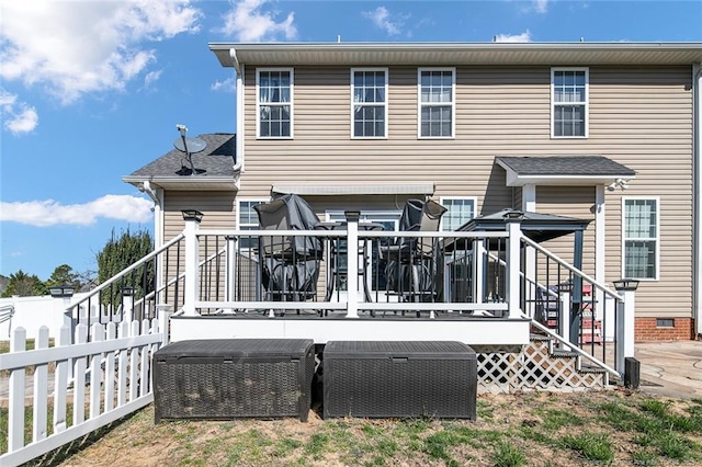 rear view of property with roof with shingles, stairway, crawl space, fence, and a deck