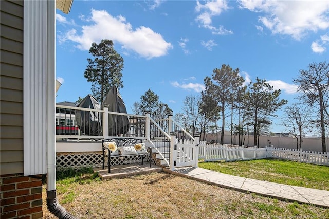 view of yard featuring fence and a deck