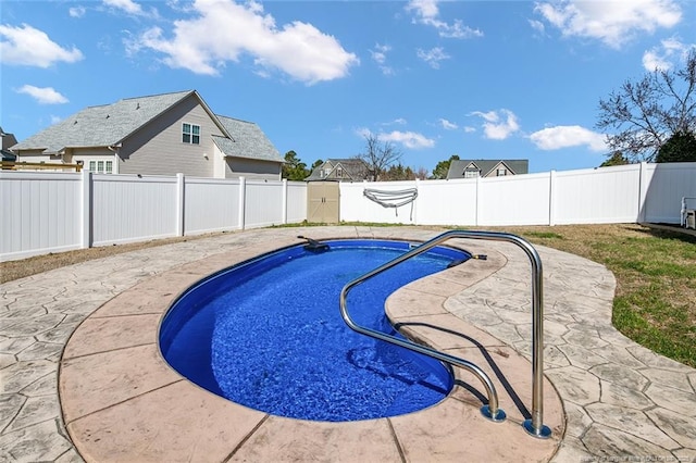 view of swimming pool with a patio area, a fenced backyard, and a fenced in pool