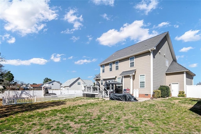 back of house featuring crawl space, a fenced backyard, a yard, and a deck