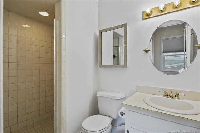 full bath featuring a stall shower, vanity, and toilet