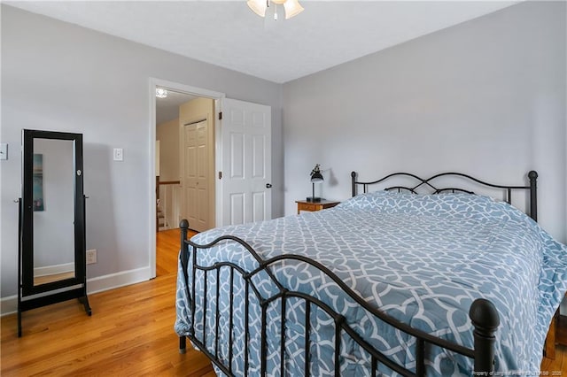 bedroom featuring light wood-style floors and baseboards