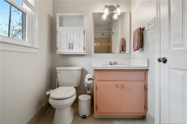 full bath with baseboards, vanity, toilet, and walk in shower