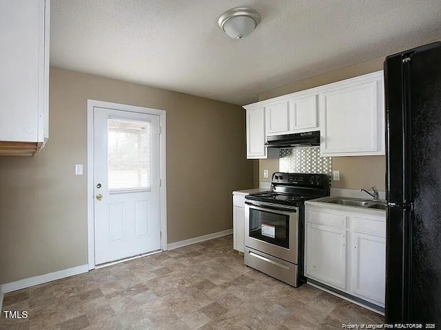 kitchen with electric range, freestanding refrigerator, white cabinets, a sink, and under cabinet range hood