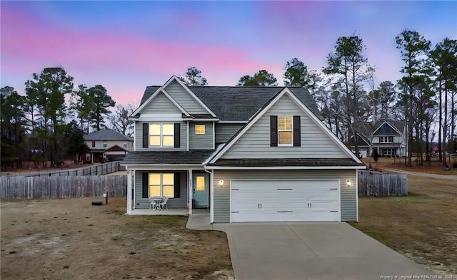 6445 Oak Grove Church Rd, Stedman, NC 28391 - traditional-style house featuring an attached garage, covered porch, fence, and concrete driveway