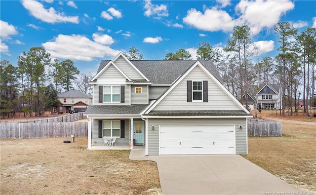 view of front of property featuring a garage, concrete driveway, a porch, and fence