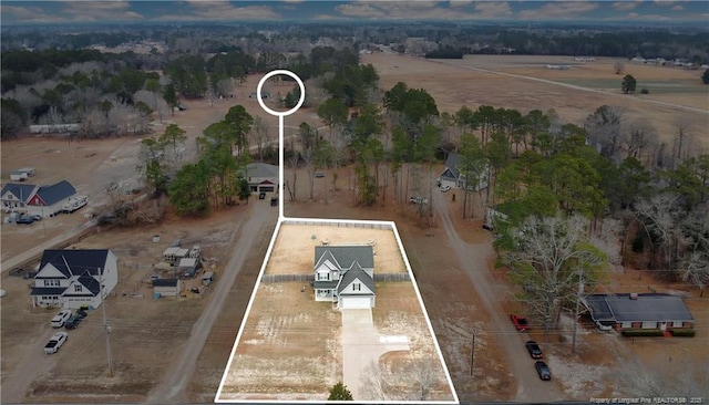 birds eye view of property with a rural view