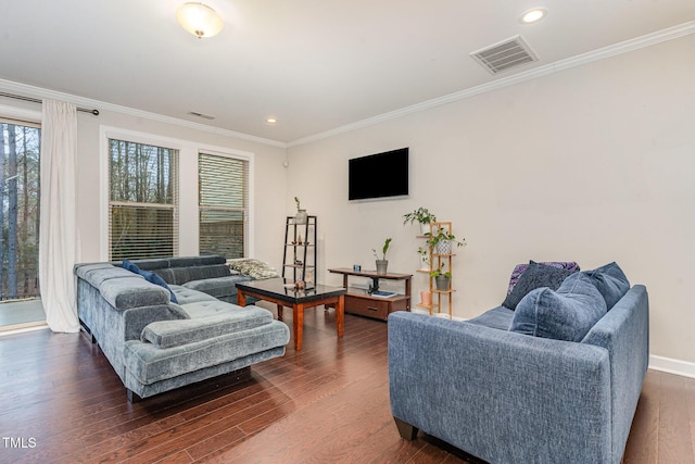 living area featuring dark wood finished floors, recessed lighting, visible vents, ornamental molding, and baseboards