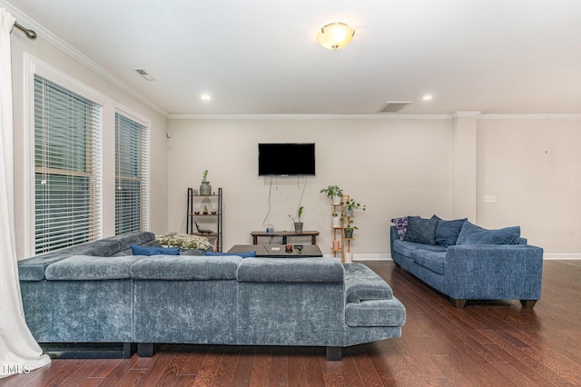 living room featuring dark wood-style flooring, visible vents, and crown molding