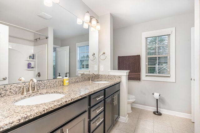 full bath with a wealth of natural light, a sink, and toilet