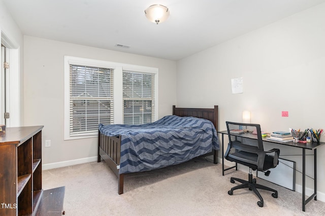 bedroom with light carpet, visible vents, and baseboards