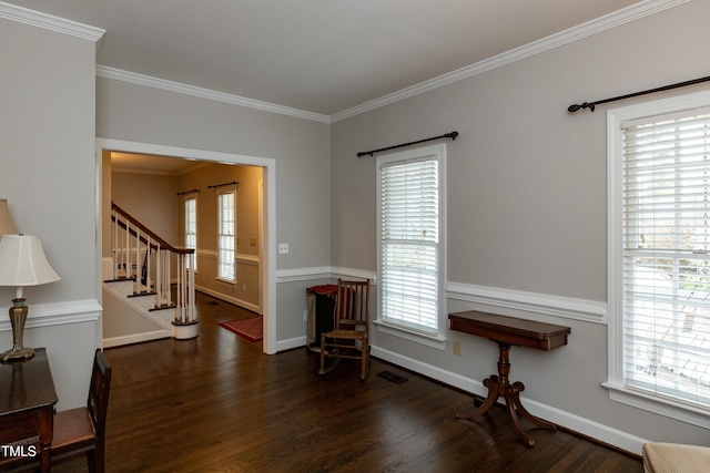 interior space featuring ornamental molding, stairs, baseboards, and wood finished floors