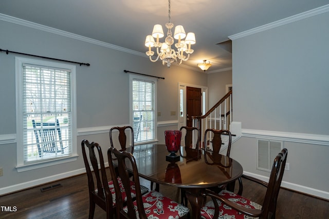 dining room with visible vents, an inviting chandelier, ornamental molding, and dark wood-style flooring