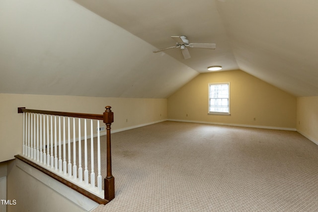 additional living space featuring ceiling fan, baseboards, carpet, and vaulted ceiling