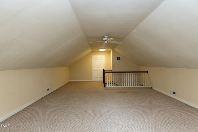 bonus room featuring visible vents, carpet floors, baseboards, and vaulted ceiling