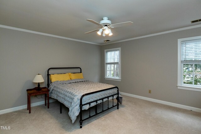 bedroom featuring visible vents, light colored carpet, baseboards, and multiple windows