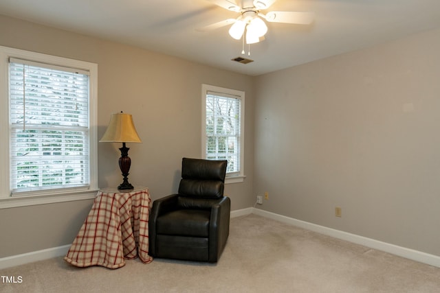 sitting room with a ceiling fan, visible vents, carpet, and baseboards