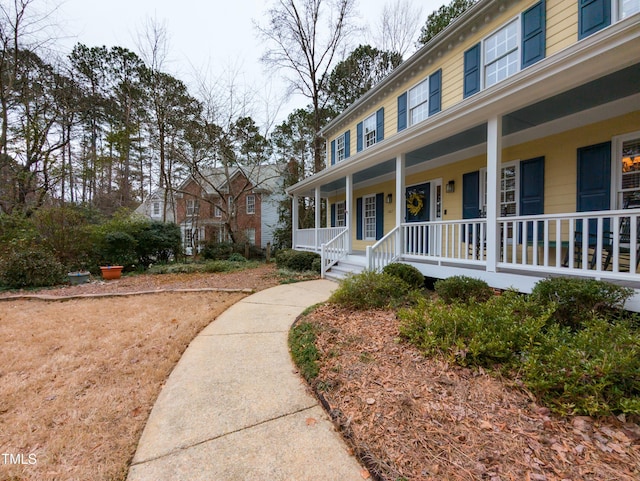 view of exterior entry with covered porch