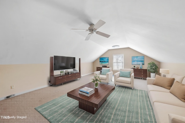 living room featuring vaulted ceiling, ceiling fan, carpet floors, and baseboards