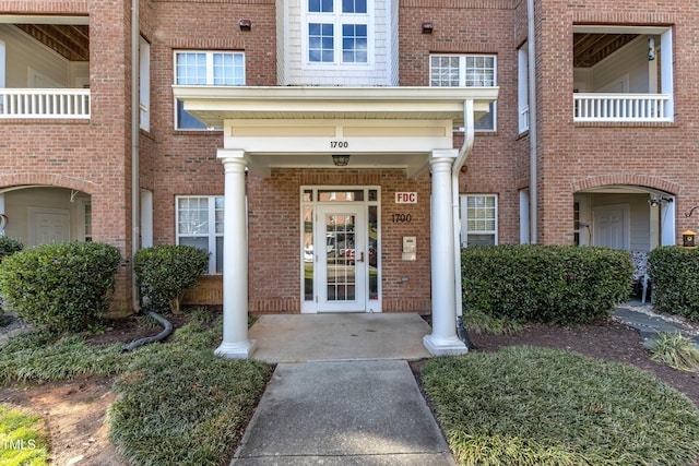 doorway to property with brick siding