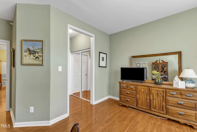 interior space with light wood-style floors and baseboards