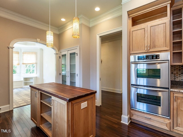 kitchen featuring open shelves, stainless steel double oven, butcher block countertops, dark wood-style flooring, and crown molding