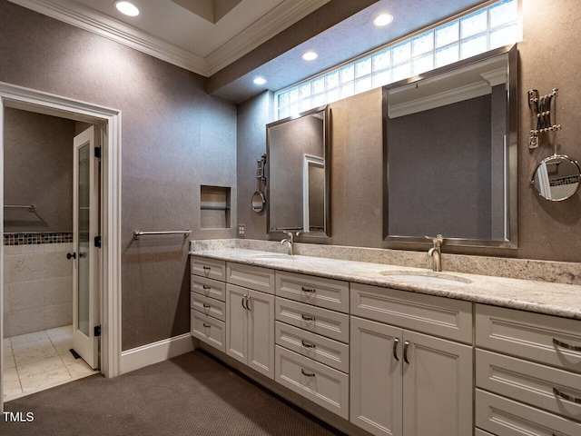 full bath with crown molding, double vanity, recessed lighting, baseboards, and a tile shower