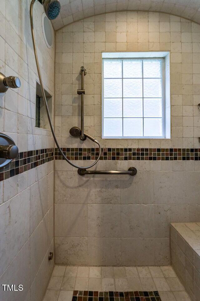 full bathroom with a tile shower
