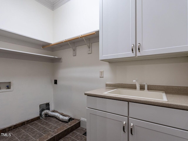 clothes washing area with cabinet space, hookup for an electric dryer, and hookup for a washing machine