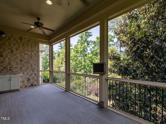 wooden deck featuring ceiling fan
