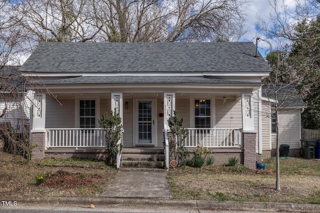 view of front of home with a porch and a shingled roof