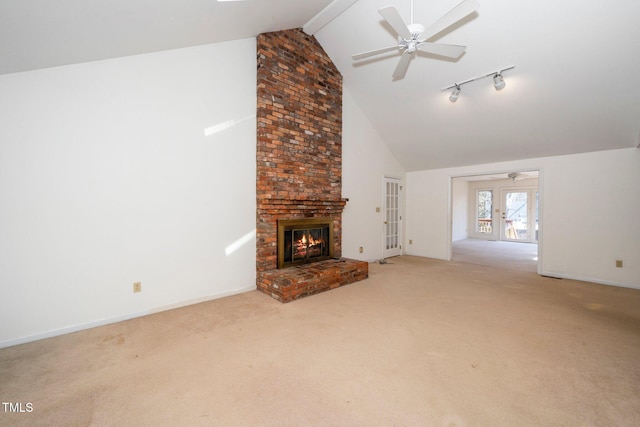 unfurnished living room featuring ceiling fan, french doors, carpet, and a brick fireplace